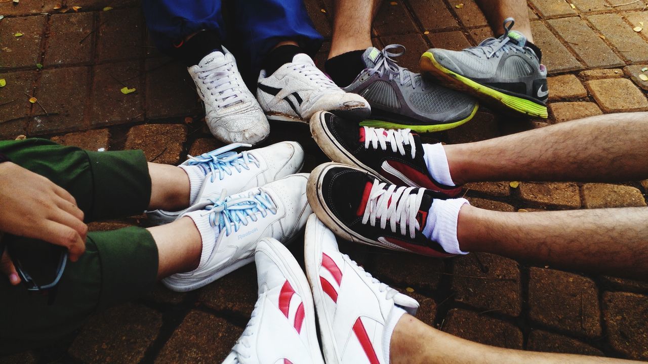 low section, men, lifestyles, person, togetherness, leisure activity, standing, shoe, high angle view, part of, bonding, human foot, friendship