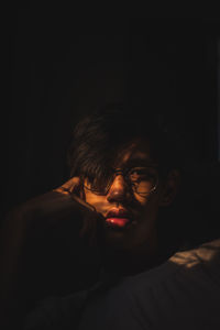 Portrait of young man in darkroom