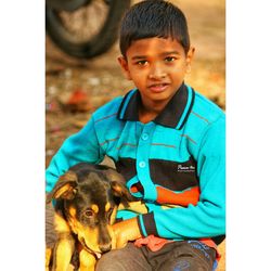 Portrait of smiling boy with dog