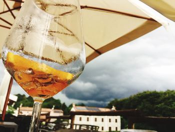 Close-up of beer in glass against sky