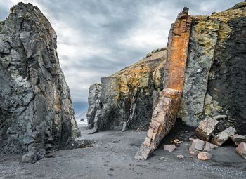 Rock formation amidst trees against sky