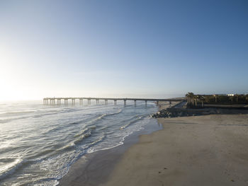 Scenic view of beach against clear sky