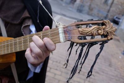 Cropped image of person playing guitar