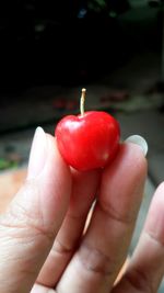 Close-up of hand holding strawberry