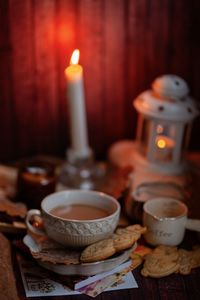 Close-up of illuminated tea light candles on table