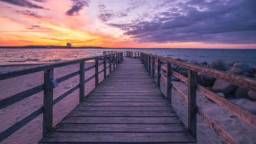 View of pier on sea during sunset