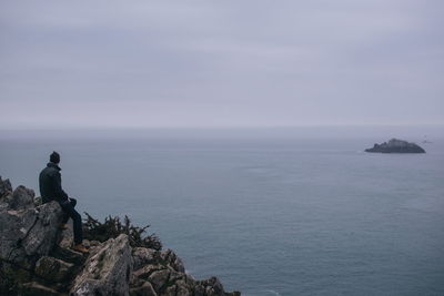 Man looking at sea against sky