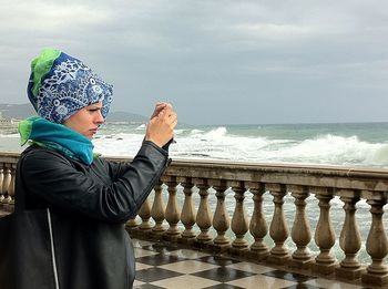 Woman standing by sea