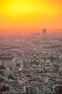 High angle view of buildings in city during sunset