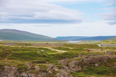 Scenic view of landscape against cloudy sky