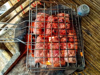 High angle view of meat on barbecue grill