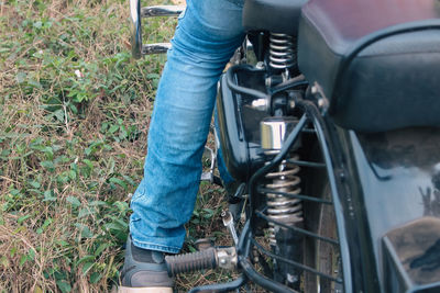 Low section of man riding motorcycle