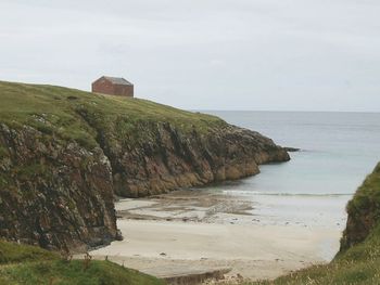 Scenic view of calm beach against sky