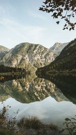 Scenic view of lake and mountains against sky