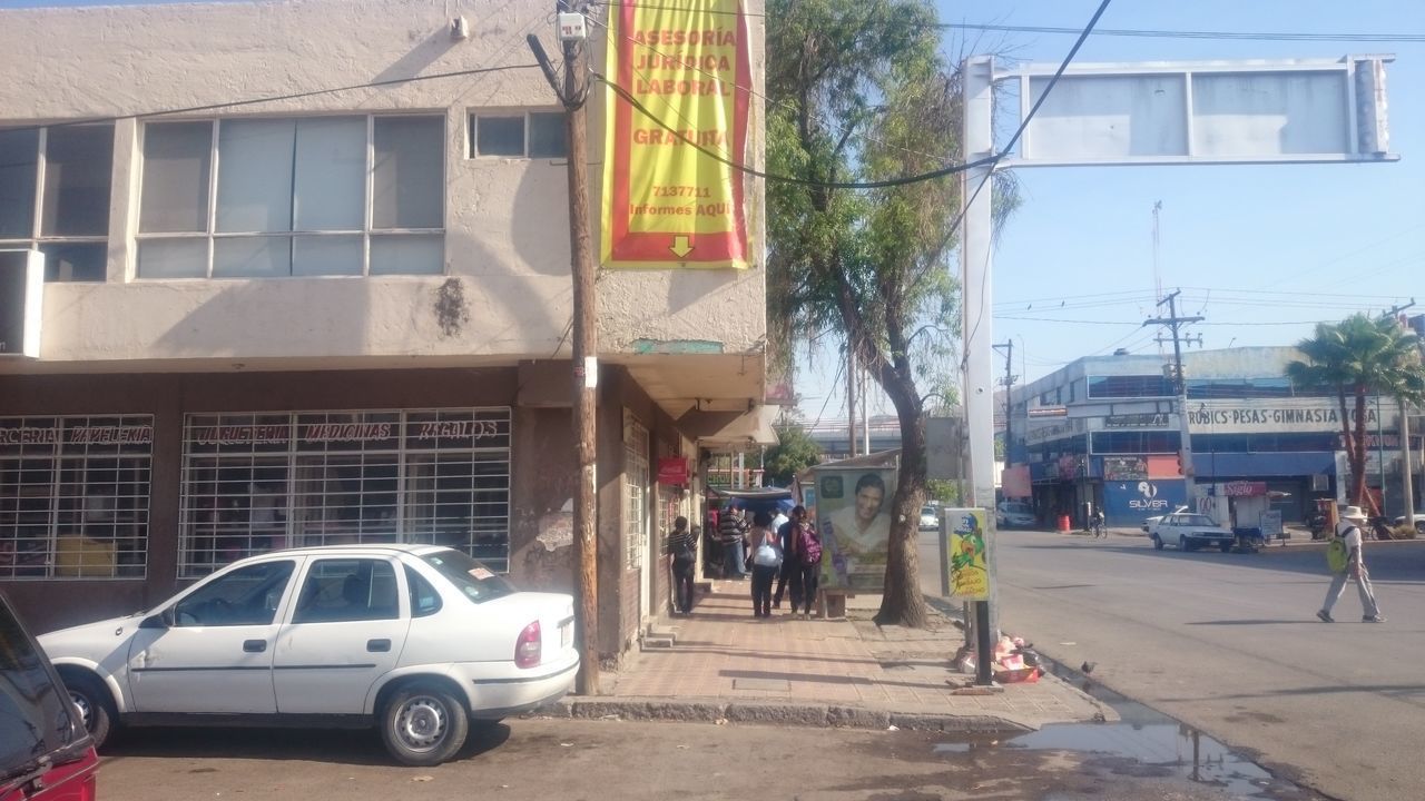 PEOPLE ON STREET AGAINST BUILDINGS