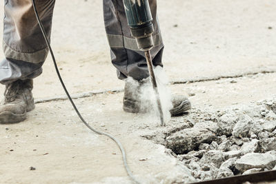 Low section of man working at dog