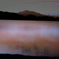 Scenic view of landscape against sky at sunset