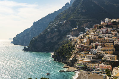 Scenic view of sea and mountains against sky