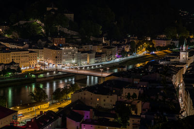 High angle view of illuminated buildings in city at night