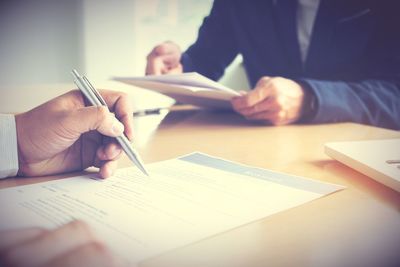 Midsection of business colleagues working on table