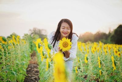 Young woman standing amidst plants