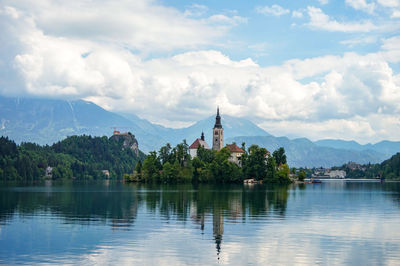 Scenic view of building by mountains against sky