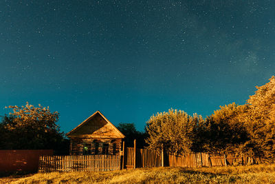 Low angle view of trees against sky at night