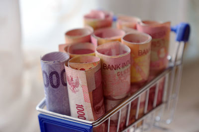 Close-up of paper currency in miniature shopping cart