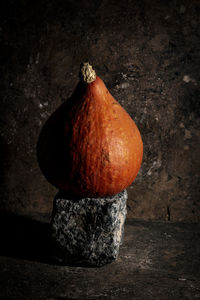 Close-up of pumpkin on table against black background