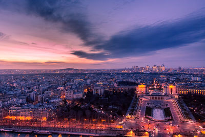 High angle view of illuminated city against sky during sunset