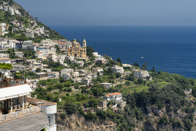 Townscape by sea against sky in city