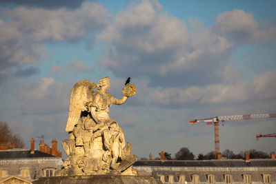 Low angle view of statue against cloudy sky