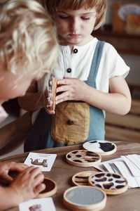 Close-up of girl playing with cookies