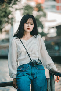 Portrait of young woman standing outdoors