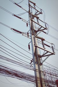 Low angle view of electricity pylon against sky