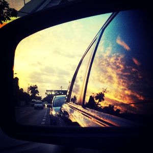 Cars on road at sunset