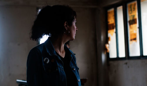 Woman looking at window in home