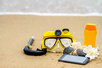 Close-up of yellow shoes on the beach