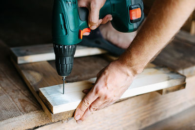 Work with a screwdriver. sewing together wooden block with a screw