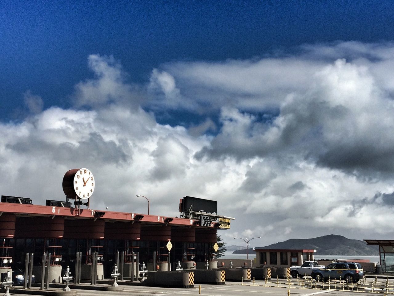 sky, cloud - sky, architecture, built structure, building exterior, cloudy, cloud, transportation, day, outdoors, weather, incidental people, overcast, city, low angle view, mode of transport, travel destinations, travel, no people, house