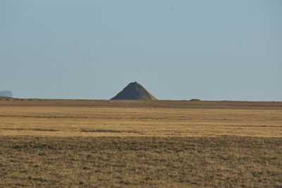 Scenic view of arid landscape against clear sky