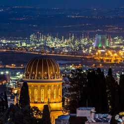 Illuminated cityscape against sky at night