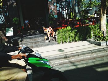 Dog sitting by man