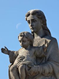 Low angle view of statue against sky
