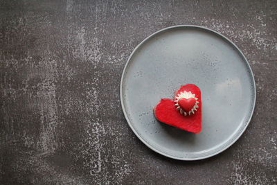 Directly above shot of red cherries in heart shape