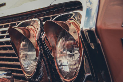 Close up of vintage bumper and car headlight at maeklong railway market in bangkok city