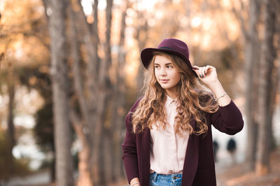 Woman wearing hat in forest