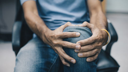 Midsection of man holding hands