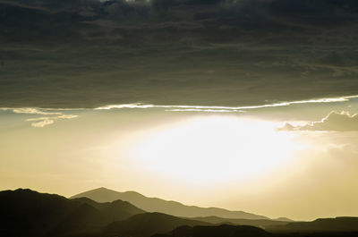 Scenic view of silhouette mountains against sky during sunset