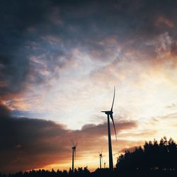 Low angle view of windmill against cloudy sky